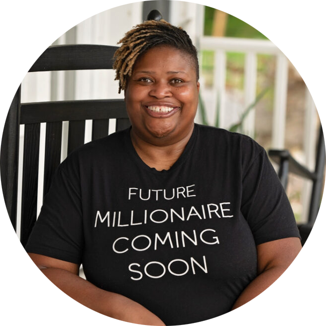 Ruby "Sunshine" Taylor, a smiling Black woman is seated on a front porch, wearing a t-shirt that reads, "Future millionaire coming soon".